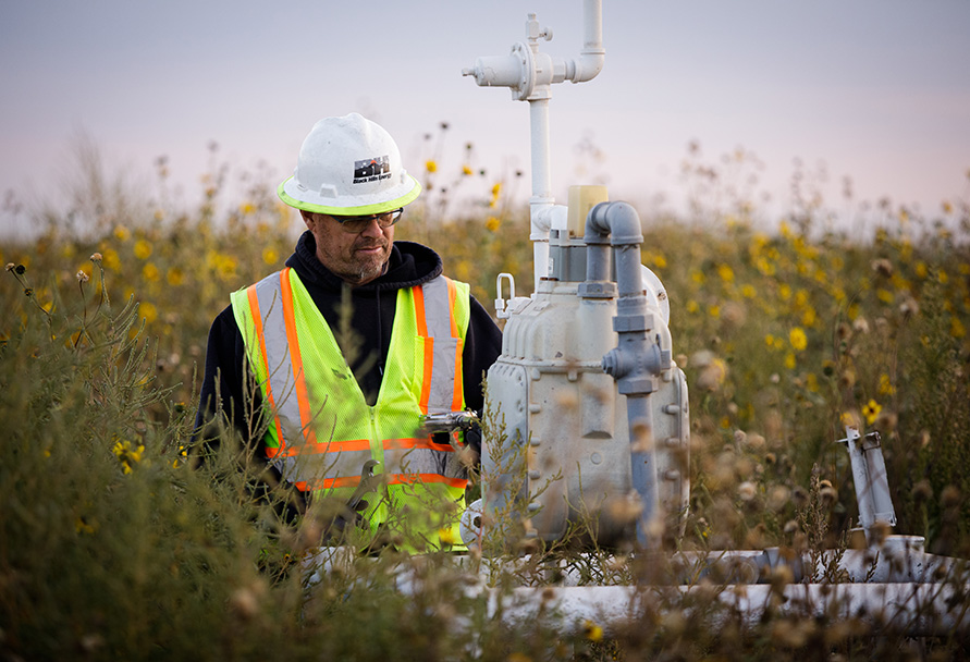 gas technician working at meter in field