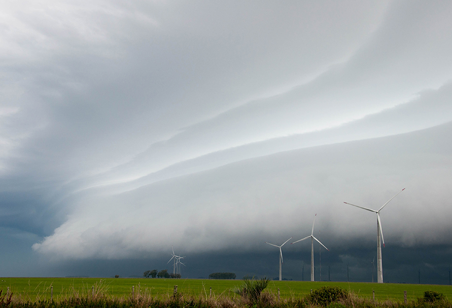 A storm front, clouds, wind turbines