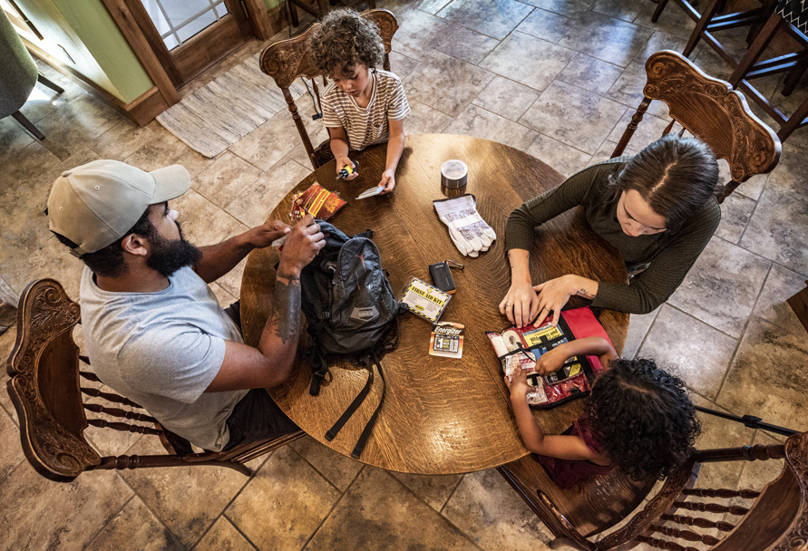 Family putting together an emergency kit at the table