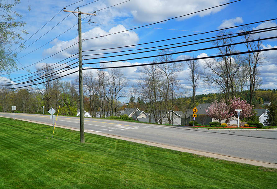 Residential area wood power pole next to road