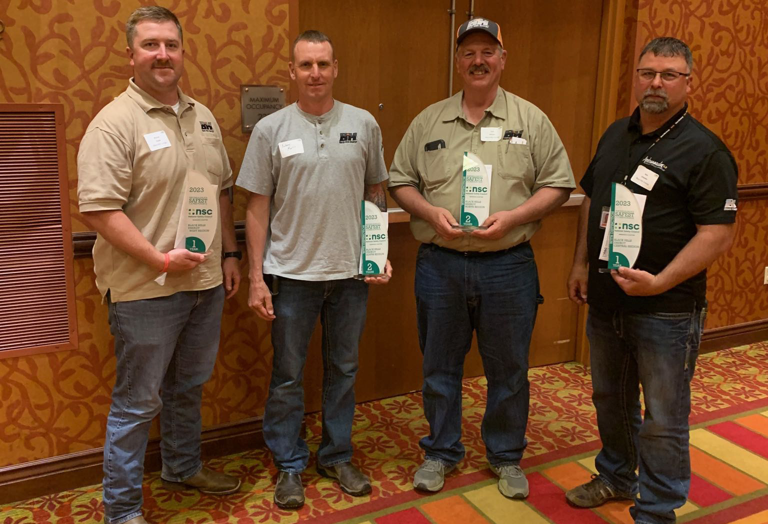 group of men posing with safety awards