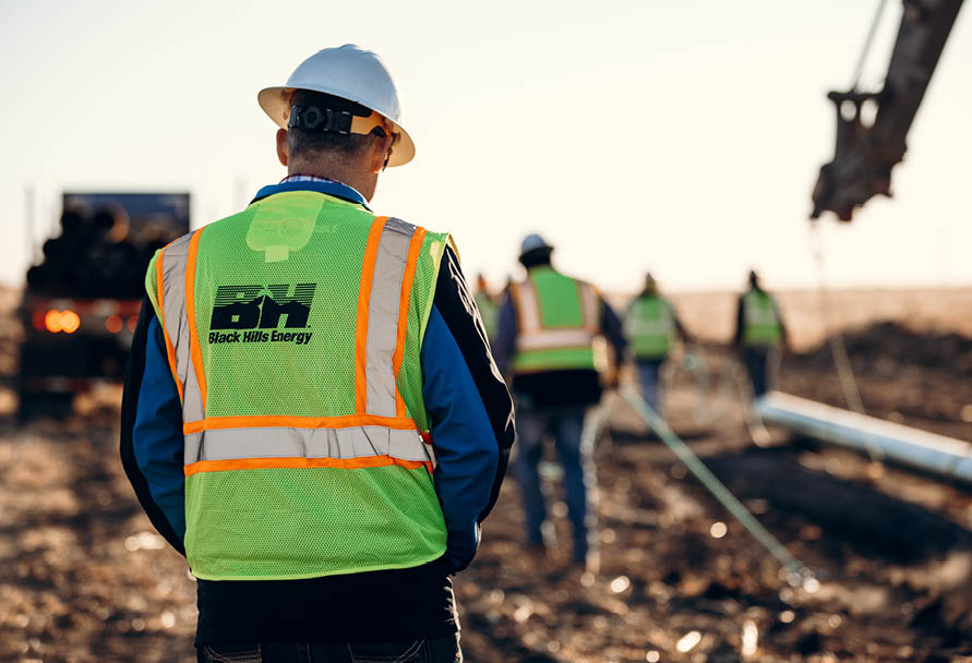 Natural gas workers in high-vis vests