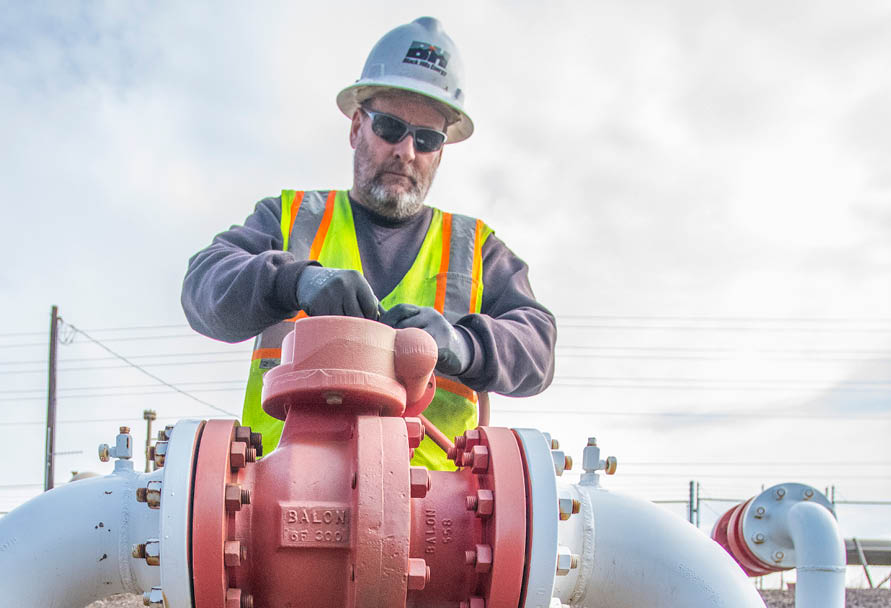 Black Hills Energy gas tech working on natural gas equipment