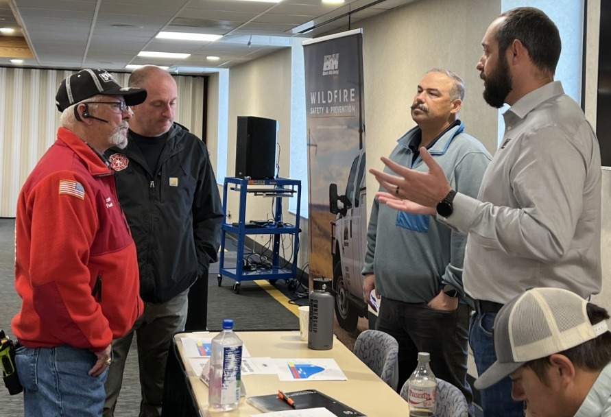 Black Hills Energy employees speaking to local first responders about wildfire safety