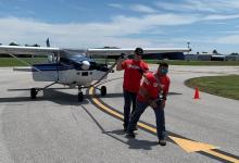 two men pulling a plane