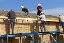 men working on buildilng house