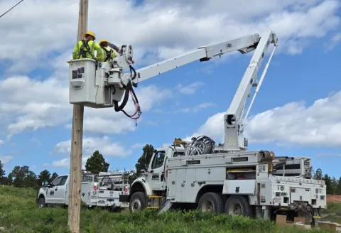 Black Hills Energy linemen working on a pole