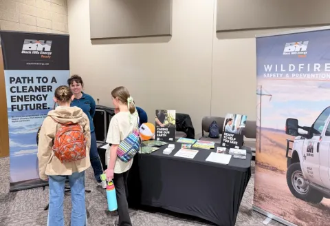 Employee talking to two people at a Black Hills Energy booth